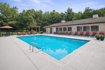 Outdoor pool with lounge chairs and pergola